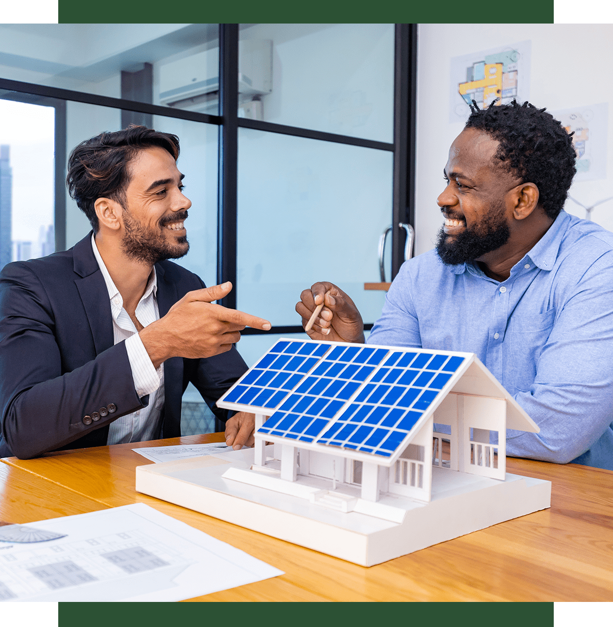 Two men discussing solar panel model.