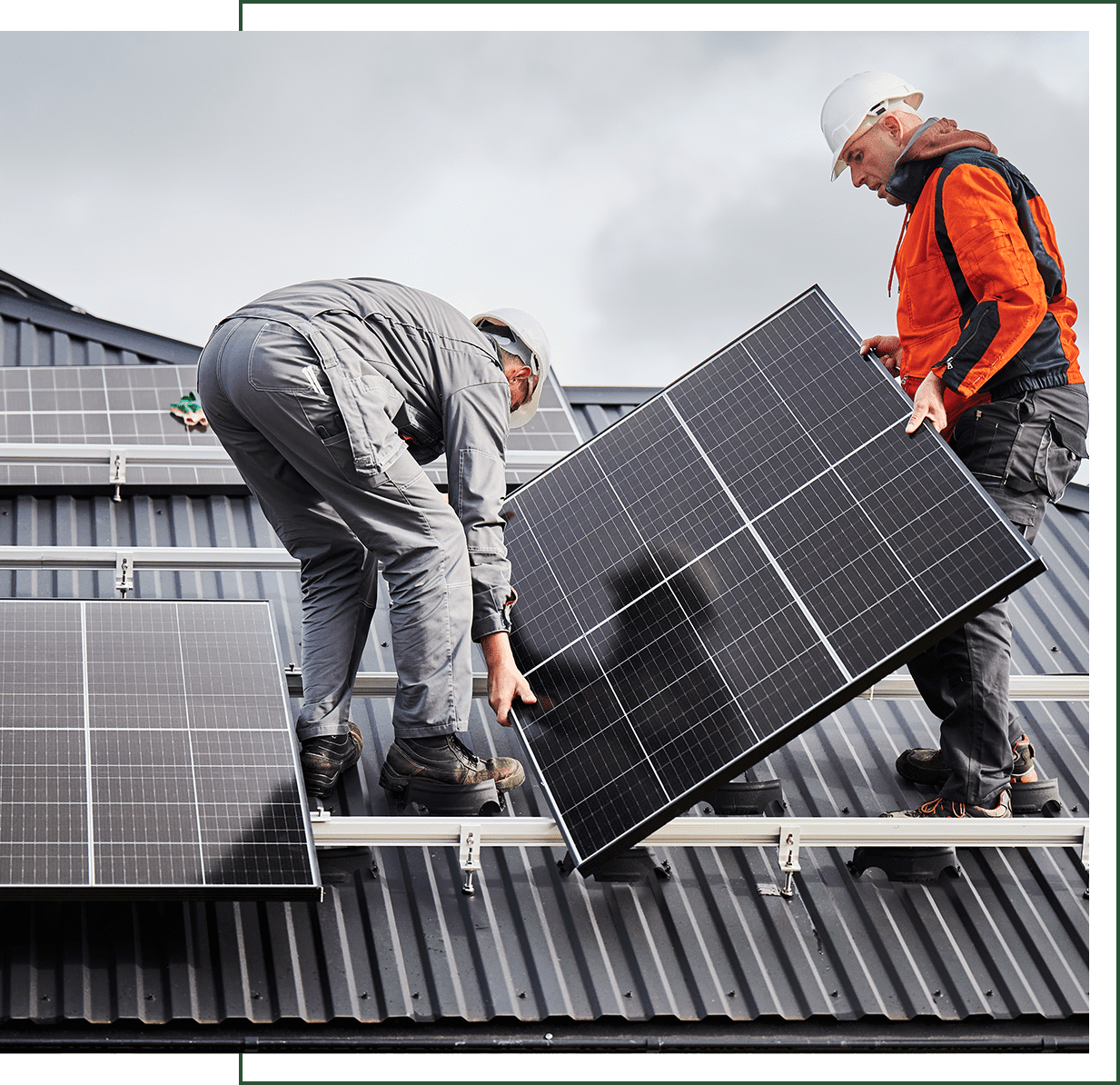 Workers installing solar panels on roof.