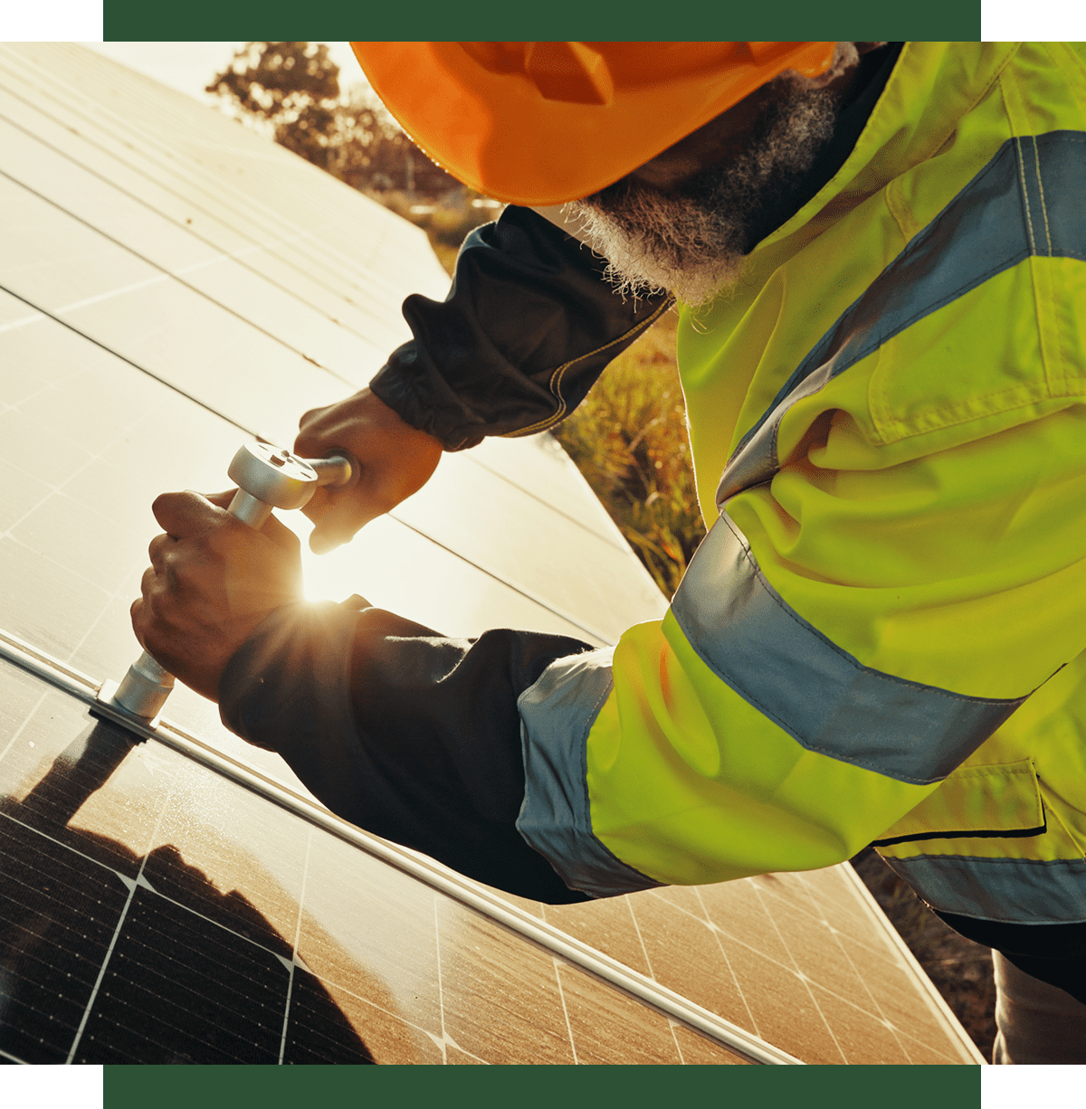 Worker installing solar panel in sunlight.