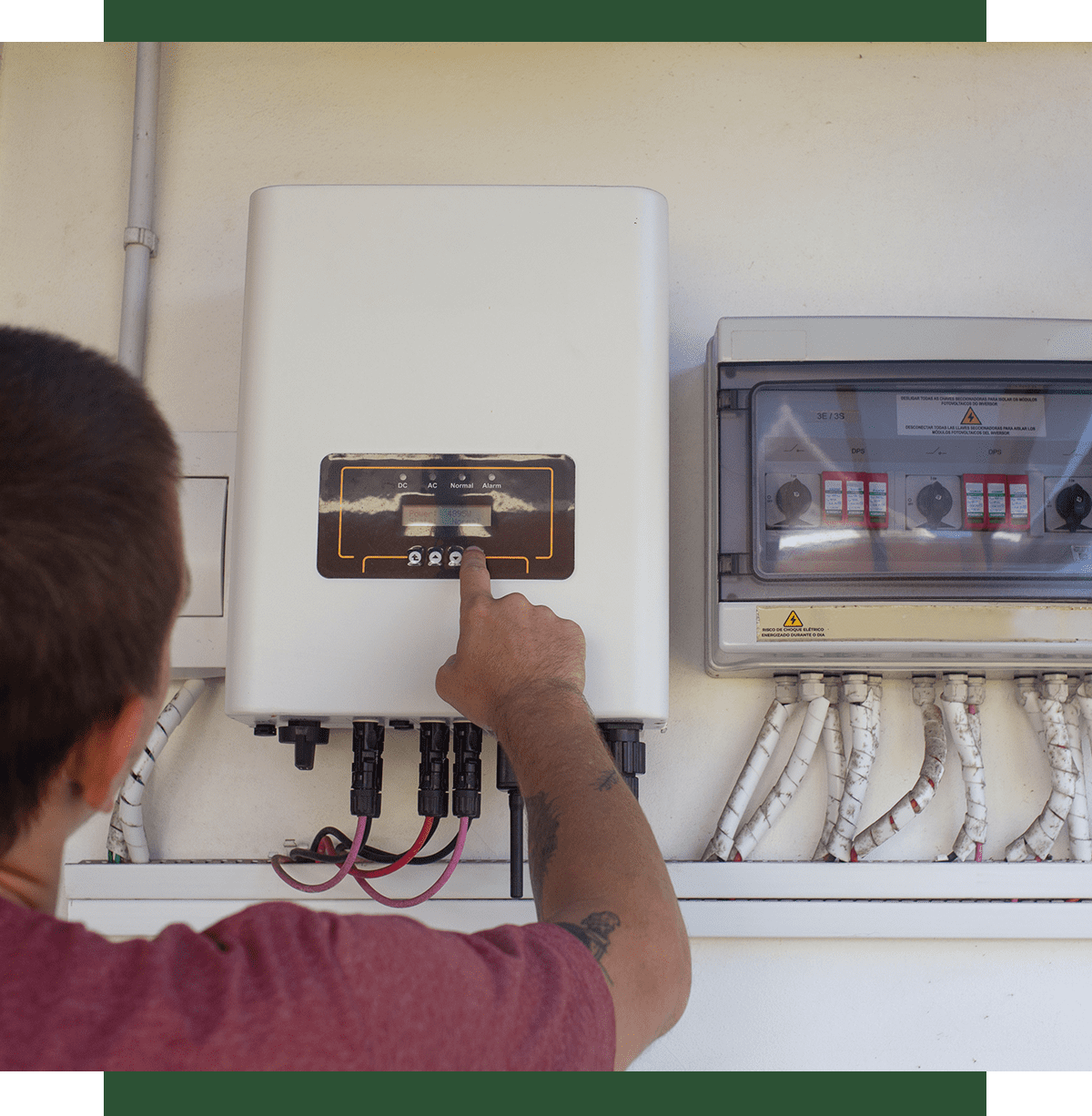 Person adjusting settings on electrical control panel.