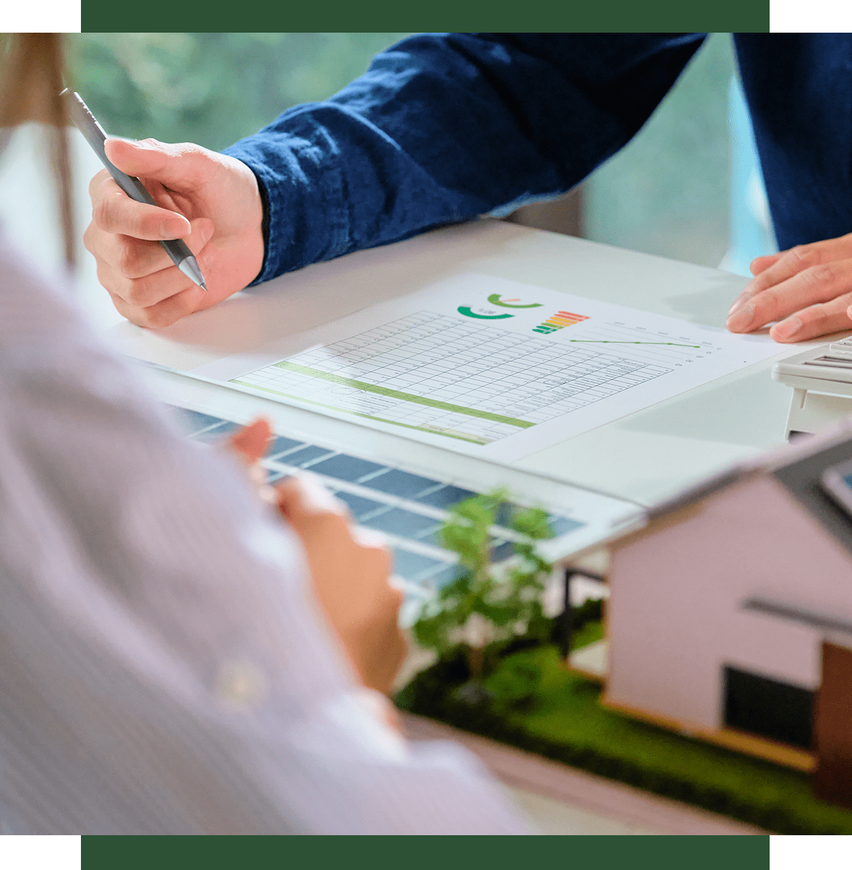 Two people discussing energy efficiency charts.