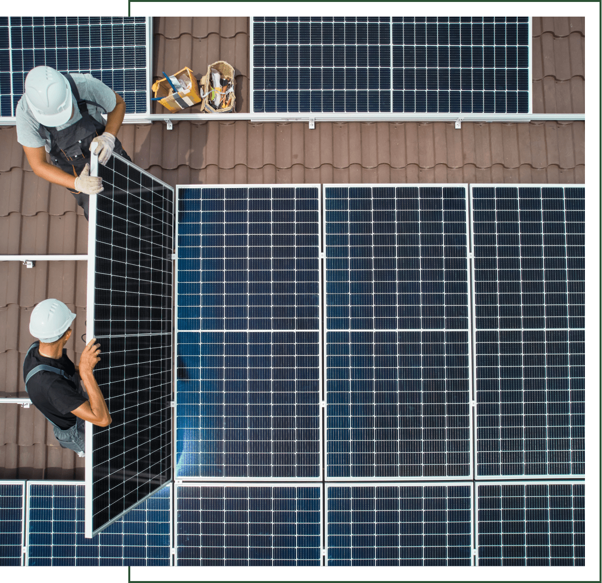 Workers installing solar panels on roof.
