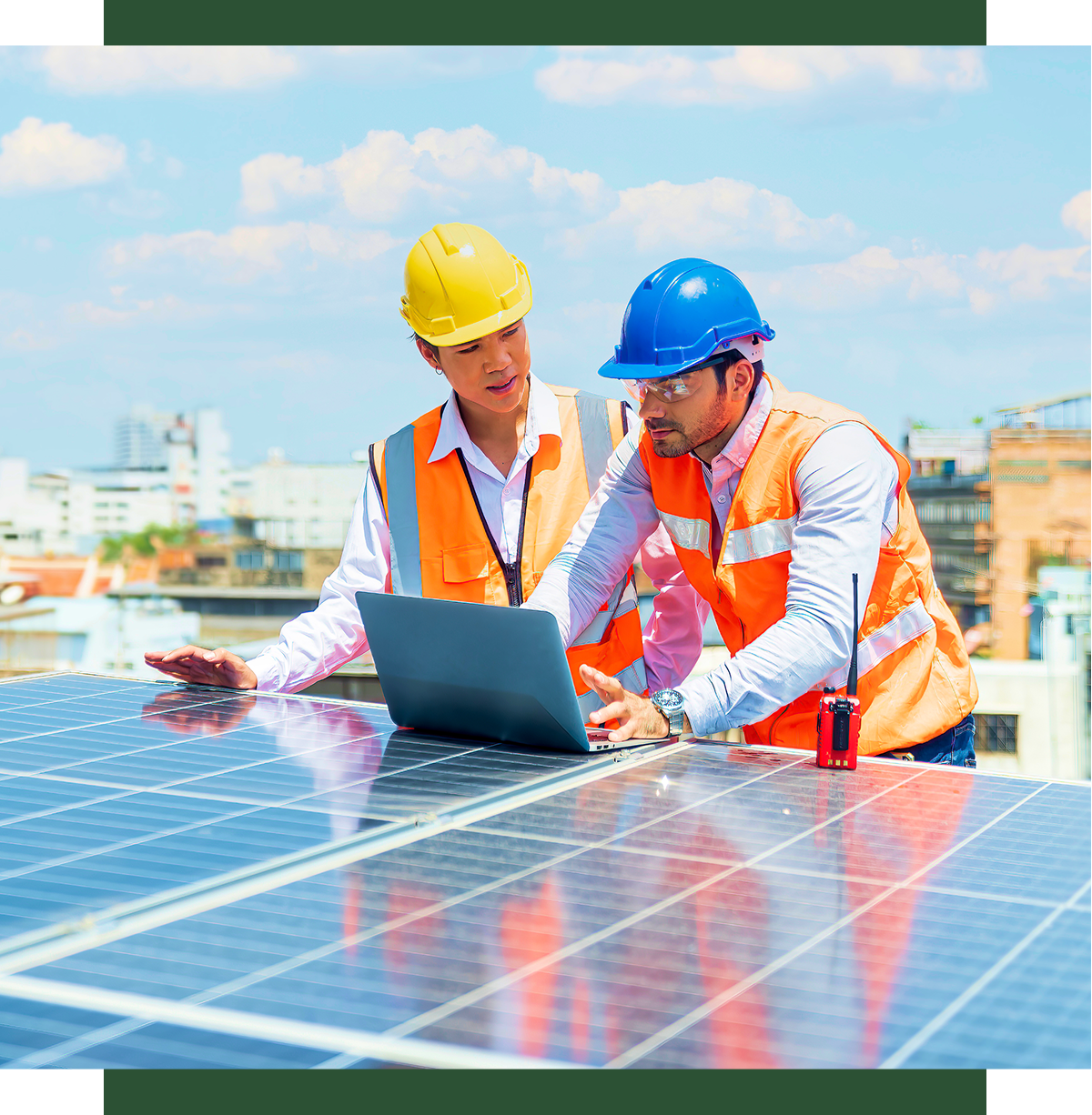 Engineers discussing solar panel project on rooftop.