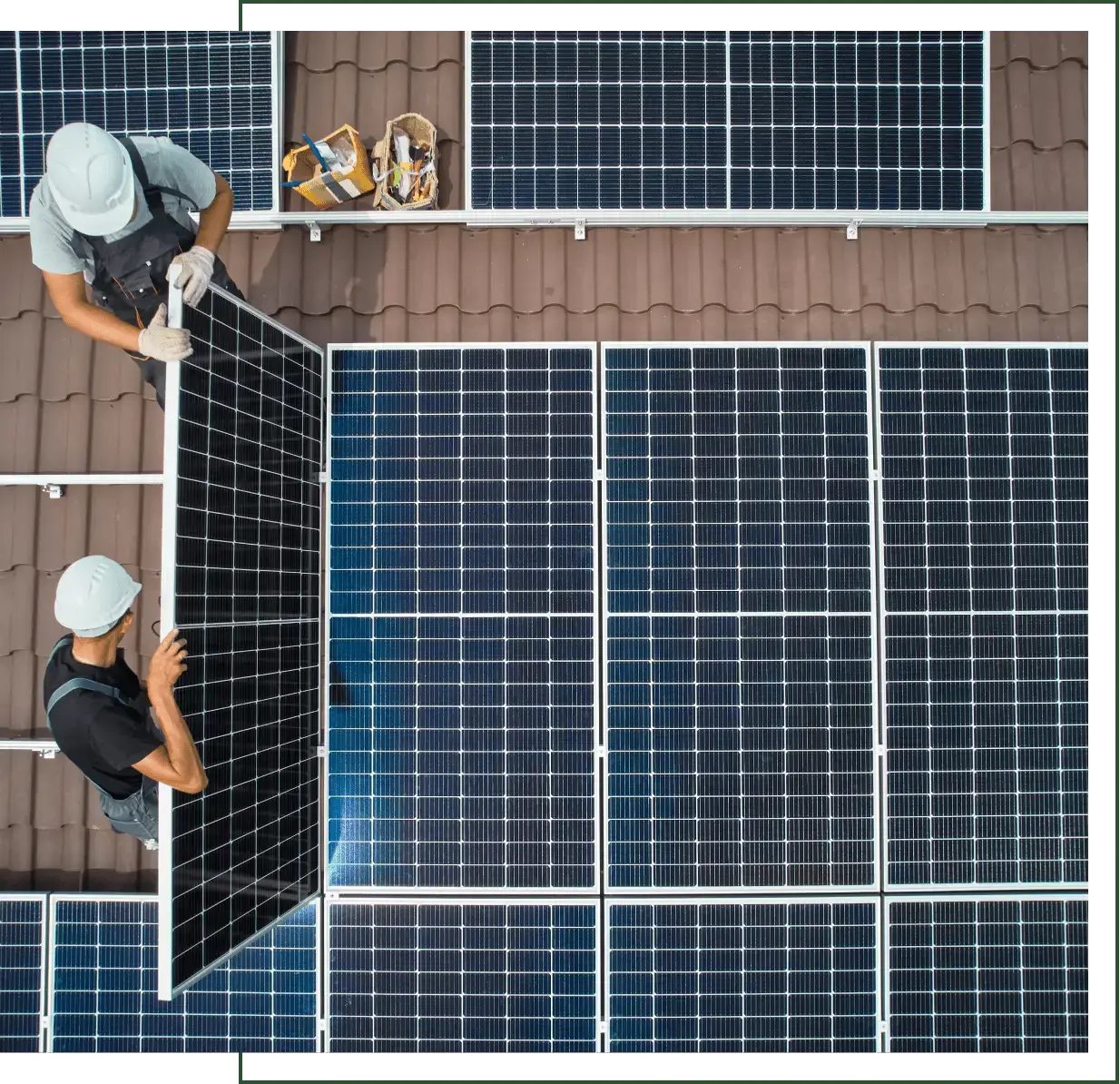 Aerial view of installers lifting a solar panel