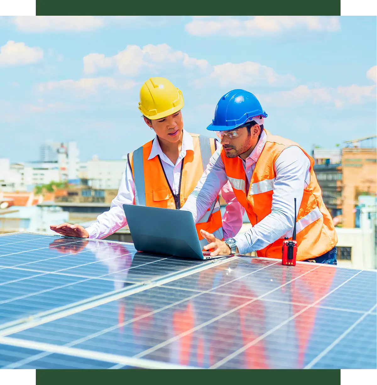 Engineers discussing solar panels on rooftop.