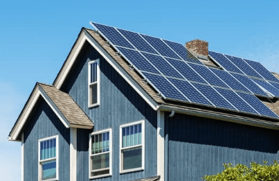 Blue house with rooftop solar panels.