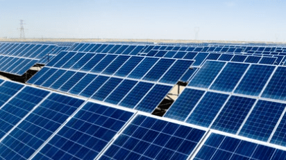 Solar panels under clear blue sky.